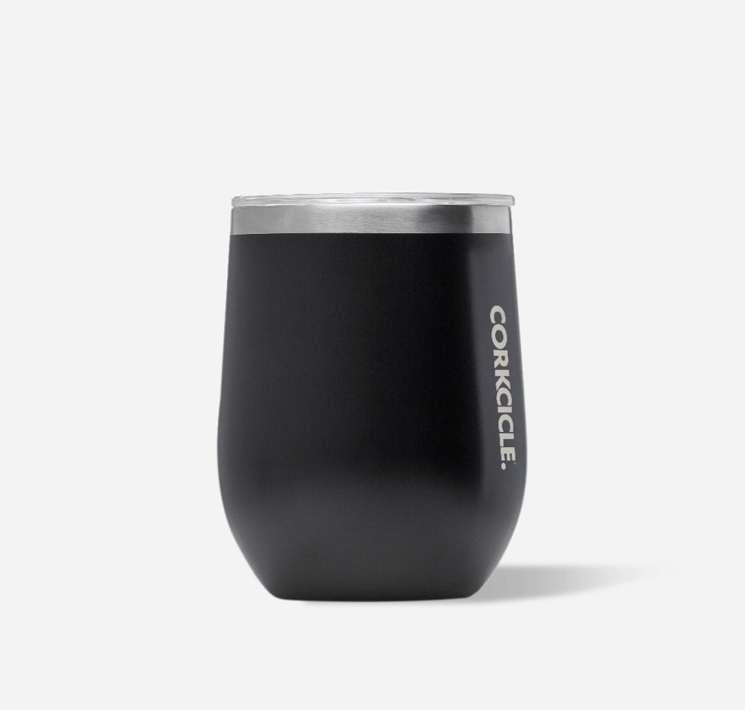 Corkcicle 12oz Stemless in Matte Black – triple-insulated stainless steel tumbler with a sleek matte black finish. Includes a clear, spill-resistant lid. Keeps beverages cold for 9+ hours or hot for 3+. A versatile and modern cup for wine, coffee, or cocktails. Available at Be Charmed.