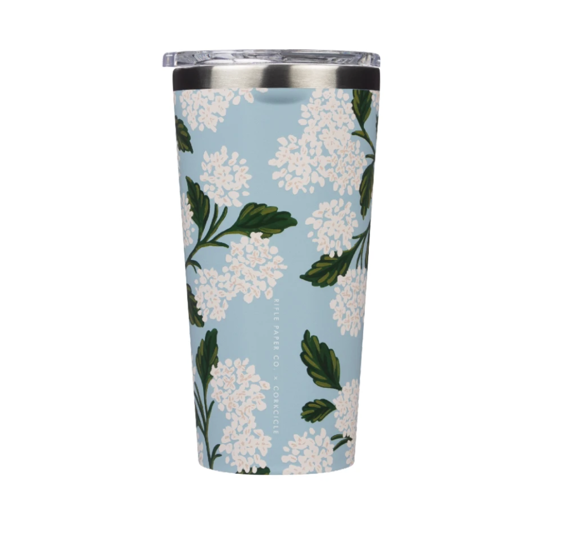 Corkcicle 16oz Tumbler – Rifle Paper Co. Hydrangea – floral triple-insulated stainless steel tumbler featuring blue hydrangeas on a white background. Includes a clear, spill-resistant lid. Keeps drinks cold for 9+ hours or hot for 3. Stylish and gift-worthy, available at Be Charmed.