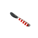Coton Colors butter knife with a red and white striped handle on a white background. Available at Be Charmed. 