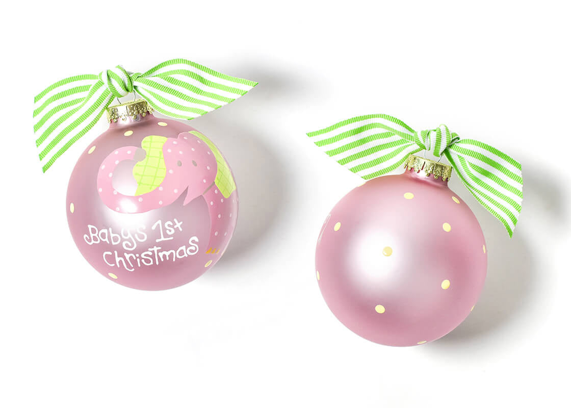 Coton Colors Baby’s First Christmas Ornament featuring a pink glass elephant with glitter ears and festive script, perfect keepsake for newborn girls – Available at Be Charmed
