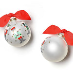 Coton Colors hand-painted Nutcracker glass ornament with festive gold-star accents, wrapped red ribbon topper, includes matching gift box—Available at Be Charmed