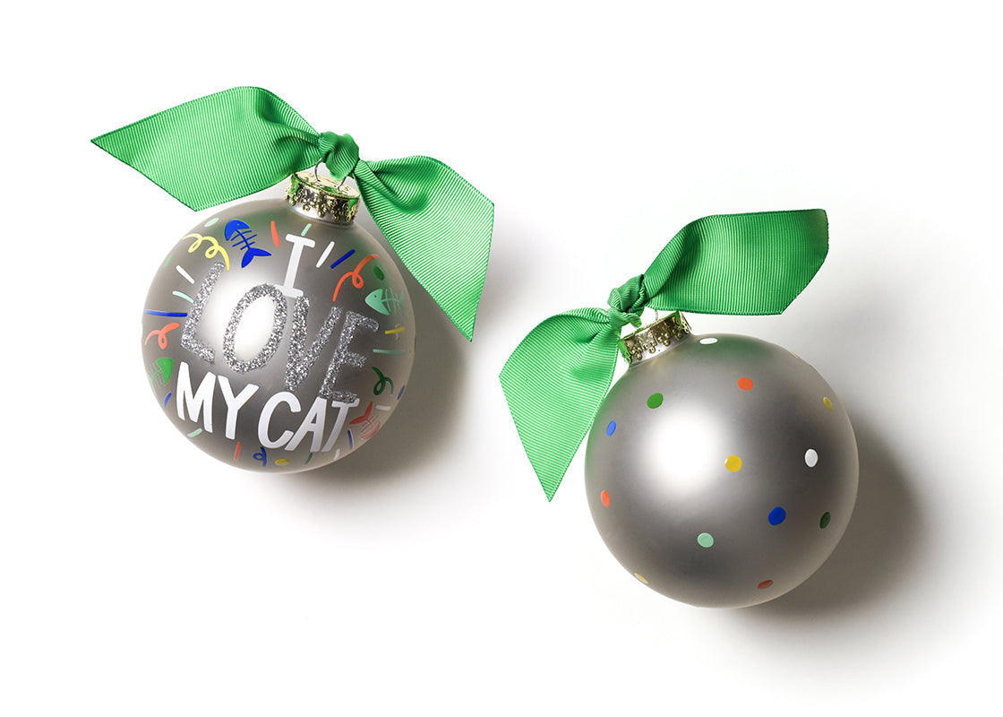 Coton Colors “I Love My Cat” oversized silver popper glass ornament with hand-painted cat face, glitter accents, coordinating green ribbon & metal swirl stand — Available at Be Charmed