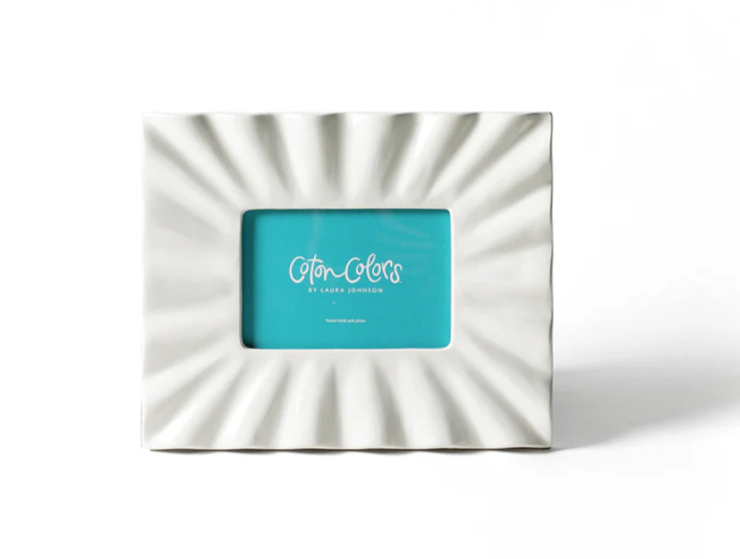 Coton Colors Signature White Ruffle Rectangle Frame – White stoneware frame with ruffled edge, holding a 4" x 6" photo, available at Be Charmed.