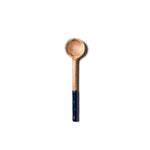 Wooden spoon with a dark handle on a white background. Available at Be Charmed