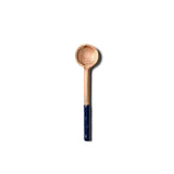 Wooden spoon with a dark handle on a white background. Available at Be Charmed