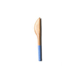 Wooden sspreader with a blue handle on a white background. Available at Be Charmed