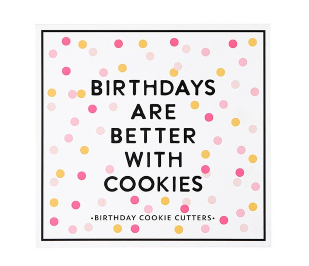 Creative Brands Birthday cookie cutter set in a magnetic book-style box with 6 stainless steel shapes (cake, balloon, candle, present, party hat, heart) and a lemon sugar cookie recipe inside lid—Available at Be Charmed