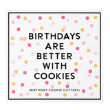 Creative Brands Birthday cookie cutter set in a magnetic book-style box with 6 stainless steel shapes (cake, balloon, candle, present, party hat, heart) and a lemon sugar cookie recipe inside lid—Available at Be Charmed