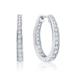 Pair of silver hoop earrings with CZ on a white background. Available at Be Charmed