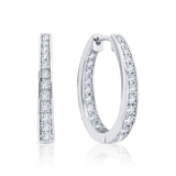 Pair of silver hoop earrings with CZ on a white background. Available at Be Charmed