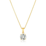 Gold necklace with a CZ pendant on a white background. Available at Be Charmed