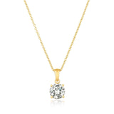 Gold necklace with a CZ pendant on a white background. Available at Be Charmed
