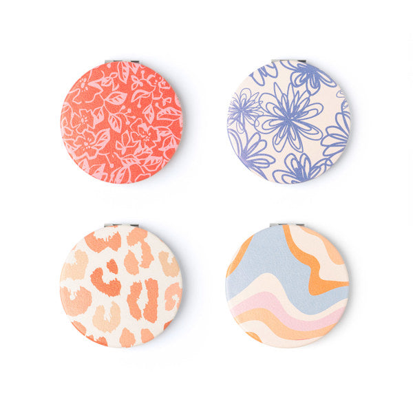 Crush compact mirror with LED touch lighting and double-sided magnification for makeup touch-ups—Available at Be Charmed