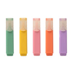 Five colorful highlighters in green, yellow, pink, orange, and purple on a white background. Available at Be Charmed