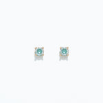 A pair of aqua and mint-colored cubic zirconia stud earrings on a white background. Available at Be Charmed
