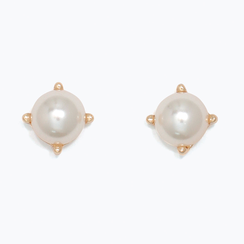 Pair of pearl earrings with gold accents on a white background. Available at Be Charmed