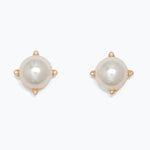 Pair of pearl earrings with gold accents on a white background. Available at Be Charmed