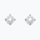 Pair of pearl earrings in silver setting on a white background. Available at Be Charmed