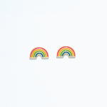 Cuties enamel rainbow stud earrings featuring vibrant multicolor enamel stripes on gold-tone hypoallergenic studs. Fun and lightweight accessory. Available at Be Charmed