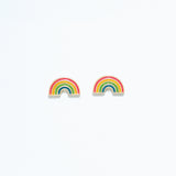 Cuties enamel rainbow stud earrings featuring vibrant multicolor enamel stripes on gold-tone hypoallergenic studs. Fun and lightweight accessory. Available at Be Charmed