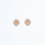 Cuties gold and pearl stud earrings with round faux pearls set in shiny gold-tone metal, designed for hypoallergenic wear. Timeless and elegant accessory for daily or special occasion use. Available at Be Charmed.