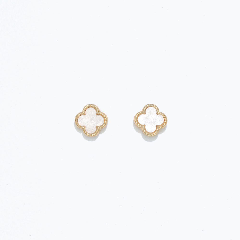 A pair of pearlized clover design earrings on a white background. Available at Be Charmed