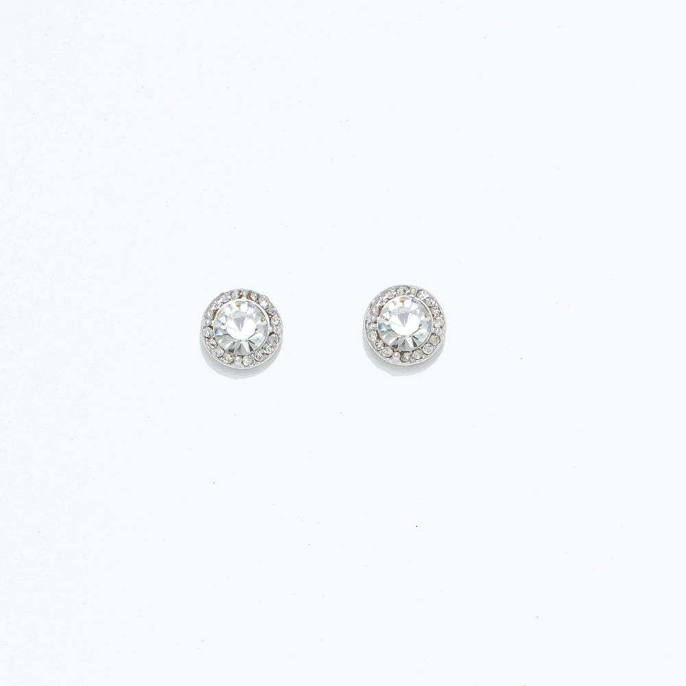 A pair of round crystal statement earrings in silver, featuring a bed of small clear crystals around a central larger crystal. Available at Be Charmed
