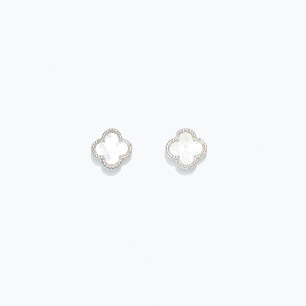 A pair of pearlized clover design earrings on a white background. Available at Be Charmed