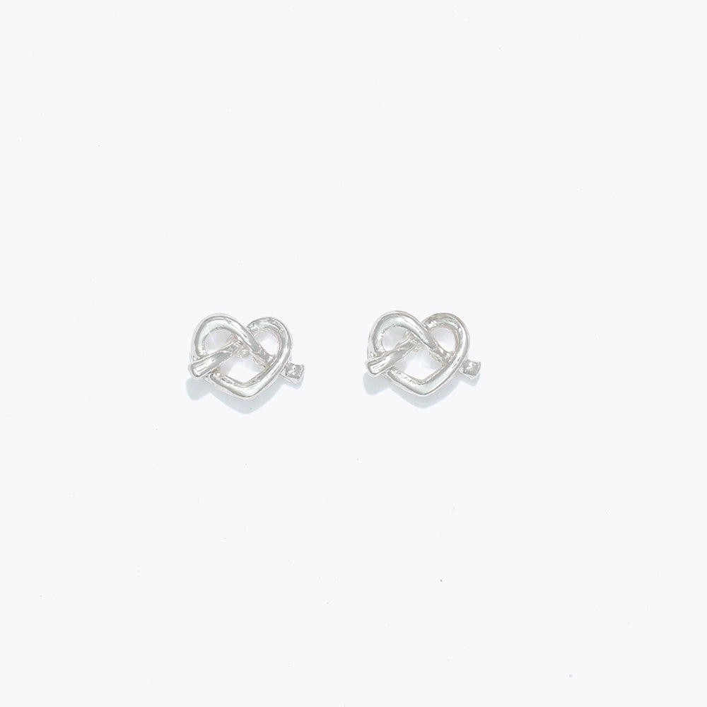 Silver Cuties Pretzel Heart Earrings with glossy gold heart‑twist design and hypoallergenic stainless‑steel posts—Available at Be Charmed