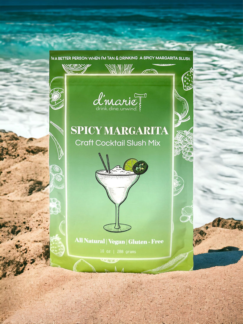 D'Marie Spicy Margarita Slush Mix pouch featuring bold jalapeño and lime design, craft cocktail mix to blend with tequila and freeze. Available at Be Charmed