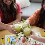 People enjoying D'Marie Spicy Margarita Slush Mix pouch featuring bold jalapeño and lime design, craft cocktail mix to blend with tequila and freeze. Available at Be Charmed