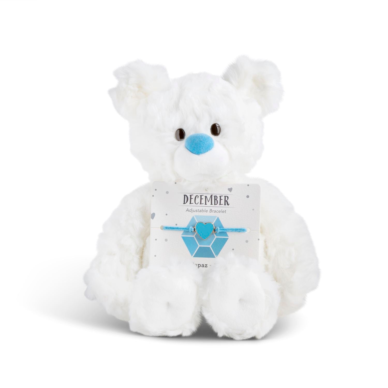 White plush bear with 'December' card with a heart bracelet on a white background. Available at Be Charmed