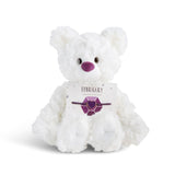 White plush bear with 'February' card with a heart bracelet on a white background. Available at Be Charmed