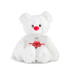 White plush bear with 'July' card with a heart bracelet on a white background. Available at Be Charmed