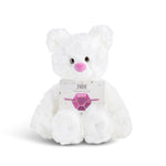 White plush bear with 'June' card with a heart bracelet on a white background. Available at Be Charmed