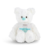 White plush bear with 'March' card with a heart bracelet on a white background. Available at Be Charmed