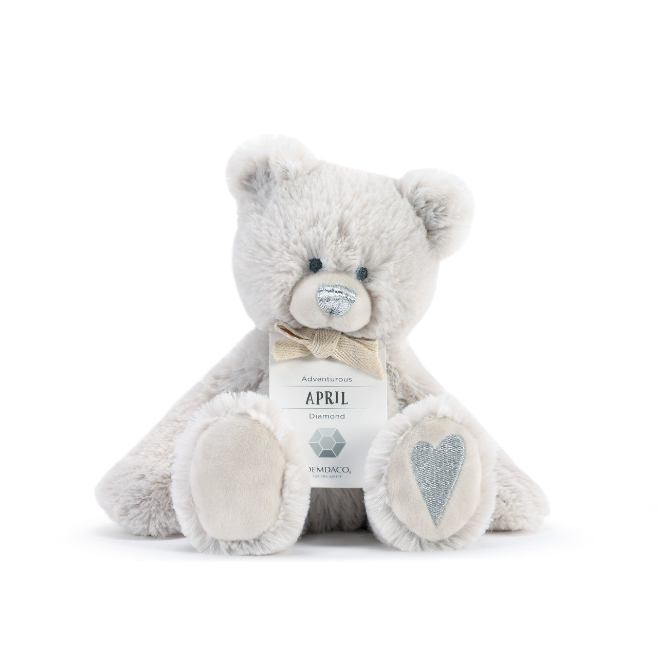 A plush teddy bear with a birthstone theme, featuring a ribbon around its neck that indicates the month of April. Available at Be Charmed