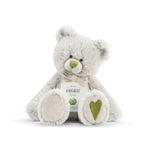 A plush teddy bear with a birthstone theme, featuring a ribbon around its neck that indicates the month of August Available at Be Charmed