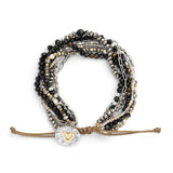 Multistrand black beaded bracelet with heart charm on a white background. Available at Be Charmed