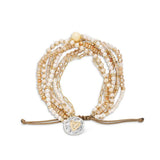 Multistrand champagne beaded bracelet with heart charm on a white background. Available at Be Charmed