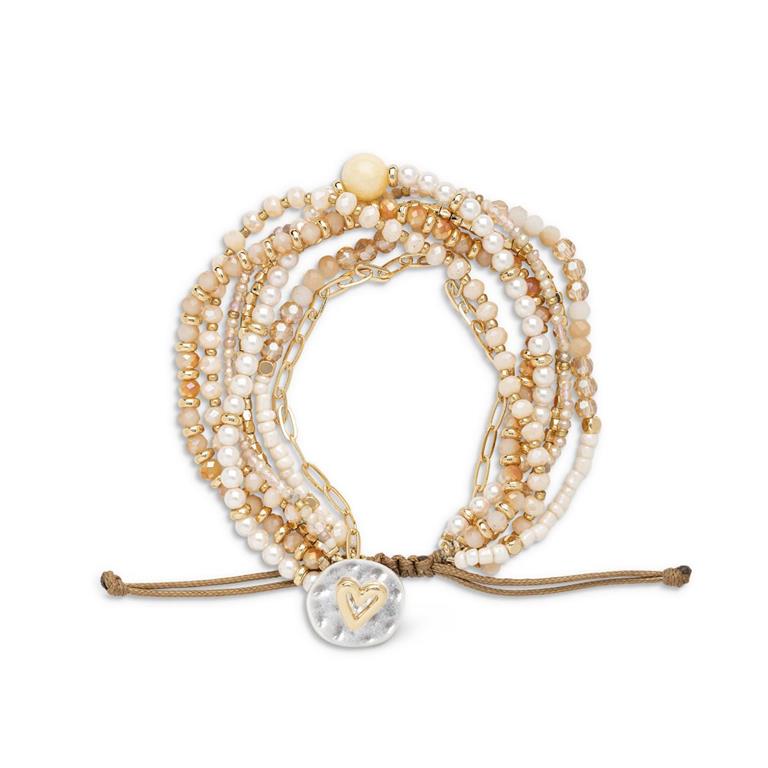 Multistrand champagne beaded bracelet with heart charm on a white background. Available at Be Charmed