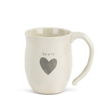 Demdaco Brave Heart Mug in cream stoneware with a heart design, available at Be Charmed.