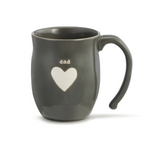 A gray ceramic mug with the word 'dad' written on it and a heart shape below. The mug appears to be made from stoneware. Availabe at Be Charmed