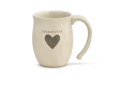 A beige ceramic mug with the word 'friendship' written on it and a heart shape symbol below the text. Available at  Be Charmed