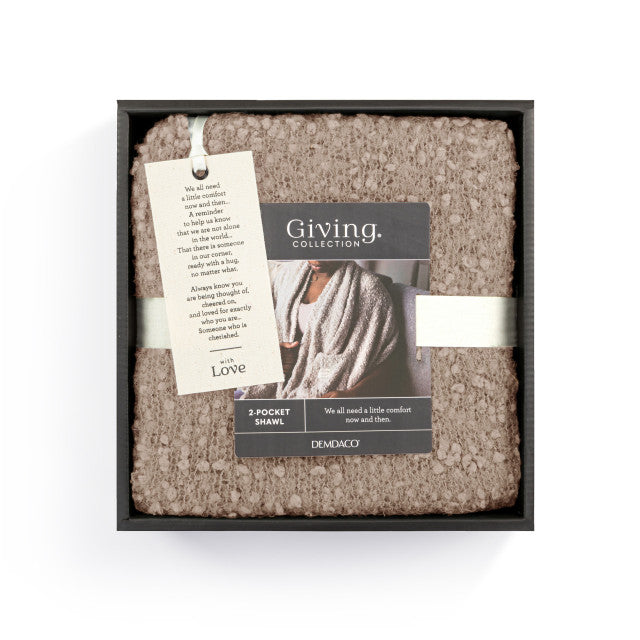 Demdaco Giving Shawl in box (27″×70″), buttery‑soft fabric with two pockets—giftable hug, available at Be Charmed.