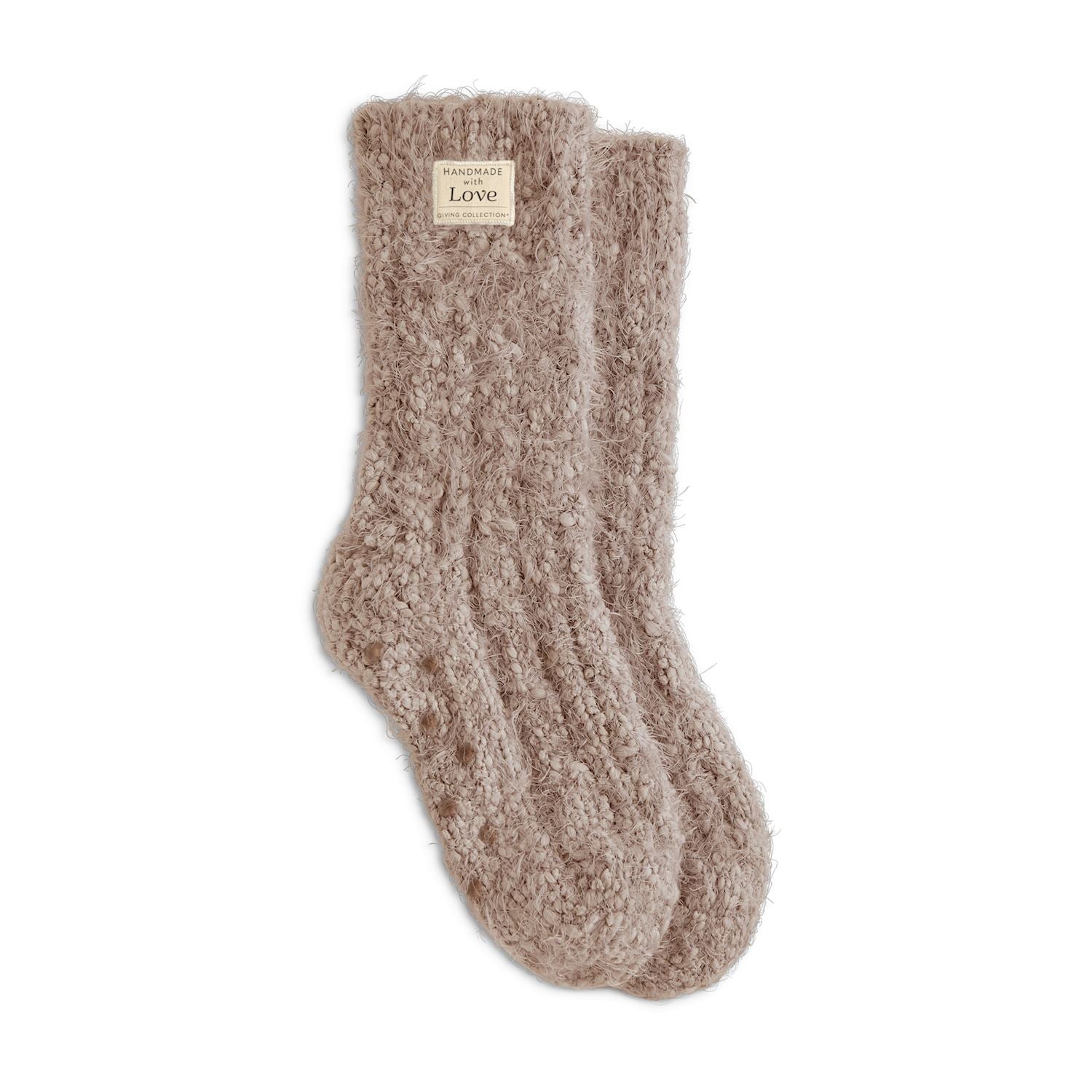 Pair of beige fuzzy socks on a white background. Available at Be Charmed