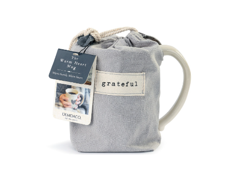 Demdaco “Grateful” Heart Mug, 16 oz stoneware with heart cutout and “Grateful” sentiment in pouch, hand-thrown feel, microwave & dishwasher safe—available at Be Charmed.
