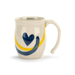 Mug with blue heart design and yellow and blue stripes on a white background