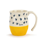 Mug with blue heart patterns yellow base and 'love' text on a white background. Available at Be Charmed