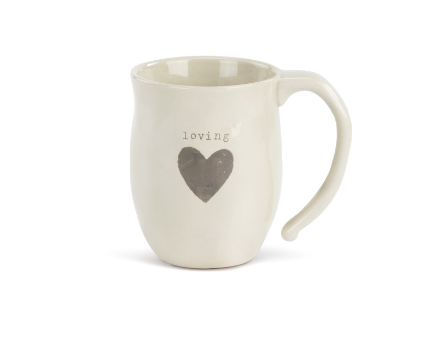Cream‑white ceramic Dema­­co Heart Mug with red heart outline and “Loving” sentiment, 12 oz capacity—perfect for coffee, tea, or hot cocoa. Available at Be Charmed